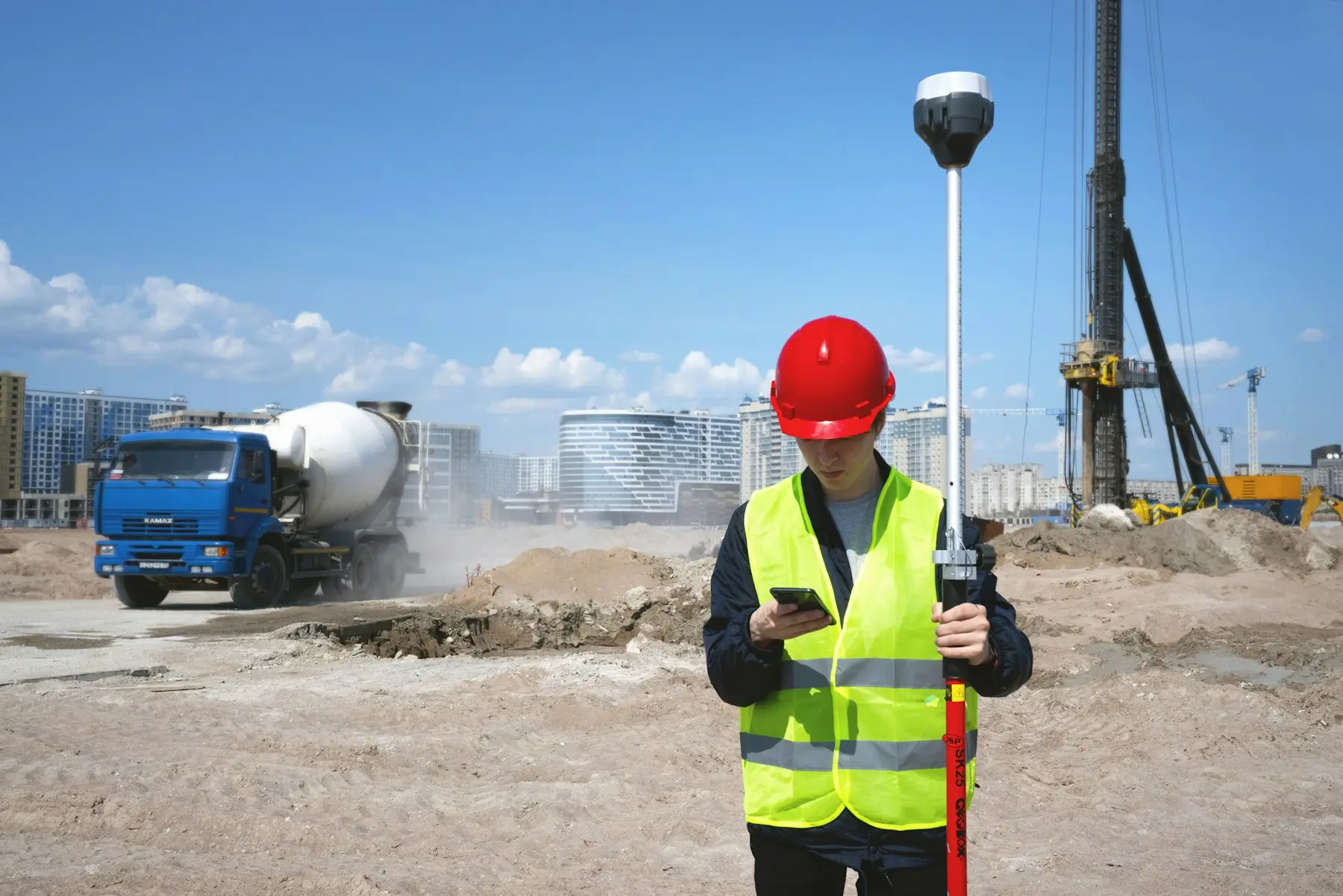 Surveyor with a GPS rover on a building site
